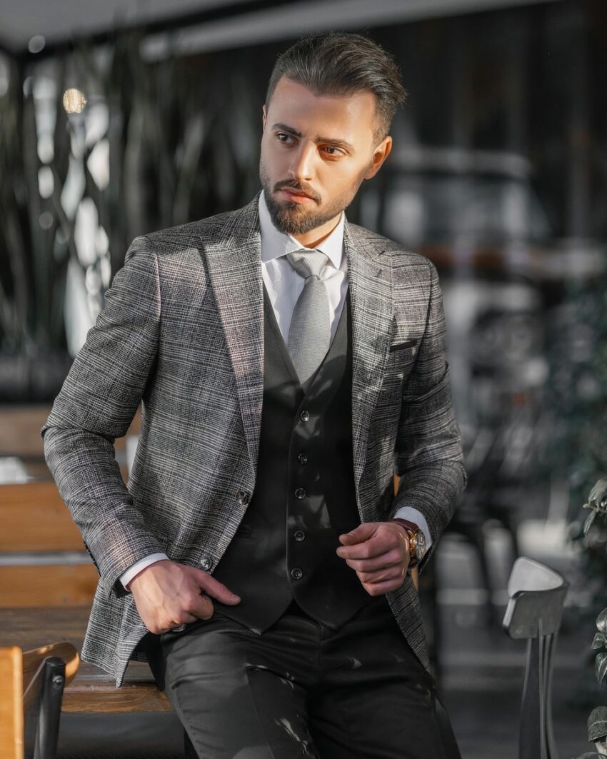 a man in a suit sitting on a bench